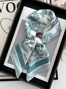 Detailed view of the dark green floral silk scarf tied elegantly in a decorative frame