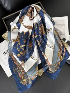 Close-up of silk-satin scarf with vintage equestrian gold chain and horse bridle patterns