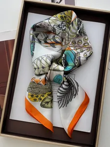 Detailed view of leaf print silk scarf in an elegant gift box with gold trim