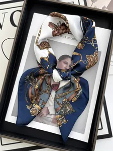 Detail of navy silk scarf with gold chain equestrian pattern on a fashion magazine
