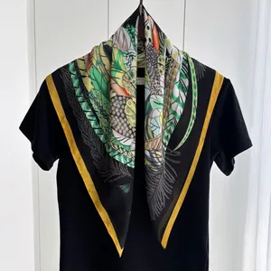 Fashionable summer silk scarf featuring vibrant tropical leaf and feather art patterns