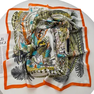 Tropical leaf and feather print silk square scarf with vibrant orange borders and silky texture