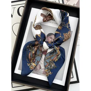 Navy blue silk-like scarf with gold chain and polka dot print on a fashion magazine