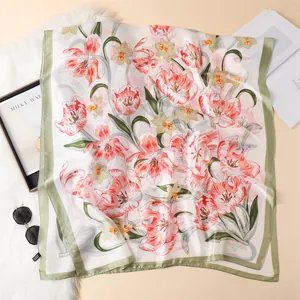 Detailed view of floral satin silk scarf with pink tulips on soft plush background