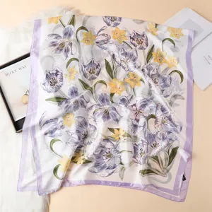 Detail view of floral satin silk scarf with purple tulips on elegant cream background