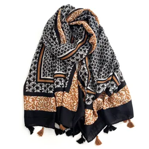 Detail of bohemian printed scarf with geometric patterns and delicate fringe tassels