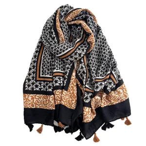 Ethnic style floral print shawl with fringe details and geometric patterns in yellow and black