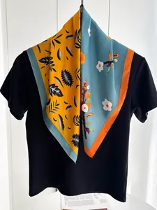 Detail of silk-texture square scarf featuring bicolored leaf and floral plant prints