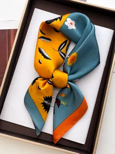 Detail of printed silk scarf with floral patterns in elegant gift box packaging