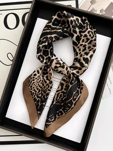 Detail of leopard print satin scarf showing smooth texture and elegant knotted drape