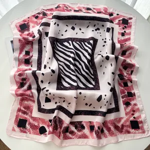 Detailed view of square silk scarf with vintage geometric and zebra print in soft pink