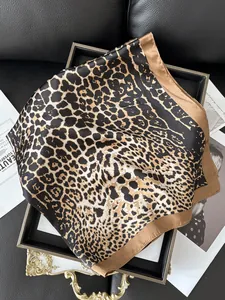 Detail of leopard print silk scarf with satin border on a vintage luxury tray