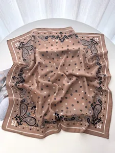 Detail shot of luxury paisley pattern satin silk scarf with elegant brown star pattern