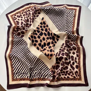 Detailed close-up of leopard print square silk scarf with purple border and stripes