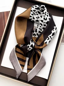 Detailed view of luxury leopard print satin scarf in elegant brown and black tones