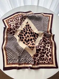 Detail of soft leopard and zebra print silk scarf showing smooth texture and drapes