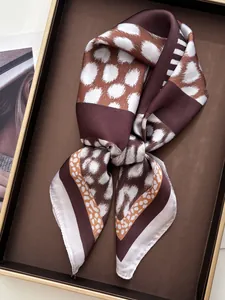 Close-up of leopard print silk scarf with retro patterns and elegant glossy texture