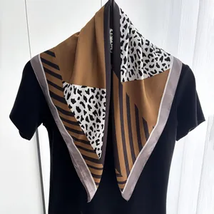Detail of silk-satin square scarf featuring leopard print and striped patchwork design