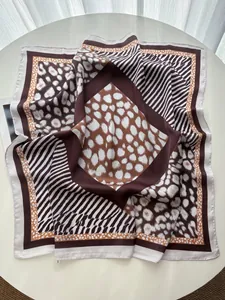 Detailed view of large square silk scarf featuring trendy leopard and zebra print patterns