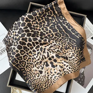Close-up of leopard print silk scarf on a stylish tray highlighting satin texture