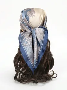 Floral print silk scarf styled as an elegant headband on wavy hair with blue accents