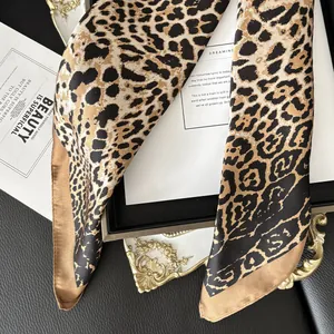 Detailed shot of leopard print silk scarf with glossy texture on luxury background