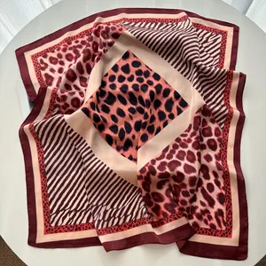 Detail of burgundy silk square scarf with mixed leopard and zebra print patterns