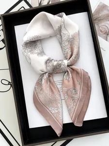 Detailed shot of pink and beige floral silk scarf tied elegantly on a black frame