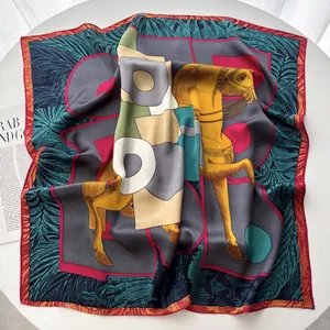 Macro detail of silk square scarf featuring artistic horse patterns and geometric colors