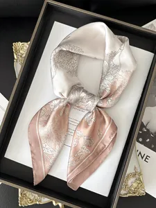 Detail of silk square scarf showing floral print and smooth champagne satin texture