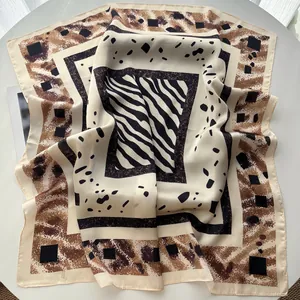 Macro detail of high-quality faux silk square scarf featuring zebra and animal print patterns
