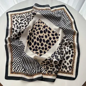 Detail of leopard and zebra print patchwork square scarf with smooth satin finish