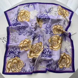 Detail of lavender silk-like square scarf with golden peony floral print and satin texture