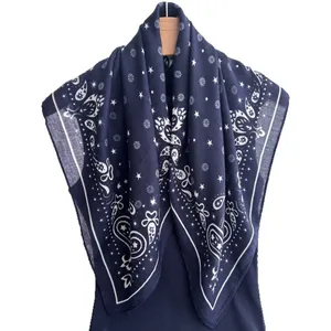 Navy paisley and star pattern silk scarf on hanger with blue sweater