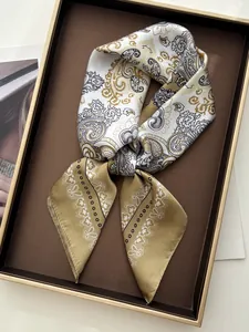 Macro detail showing paisley and floral print on premium silk scarf for women