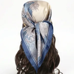 Elegant floral square silk scarf in grey-blue and champagne used as a hair accessory