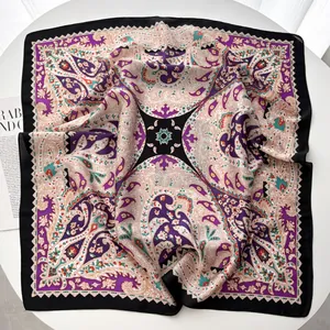 Macro detail of silk-like square scarf with paisley patterns and elegant purple edges