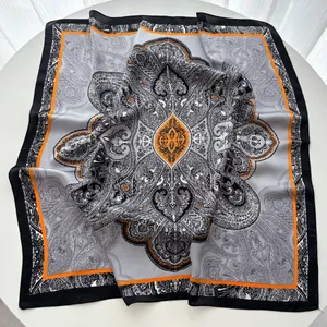 Detailed view of the paisley and mandala pattern on the orange and black silk scarf