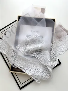 Detailed close-up of white mesh lace veil with exquisite rose crochet patterns