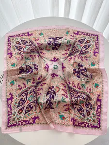 Detail showing paisley pattern on purple silk scarf with premium satin finish texture