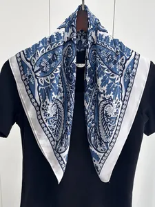 Detail of vintage paisley silk scarf featuring navy blue and white floral patterns