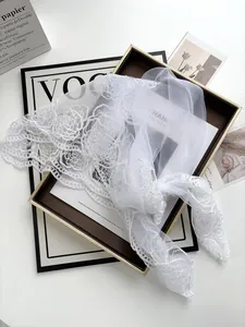 Close-up of white rose floral lace bridal veil featuring intricate mesh embroidery detail