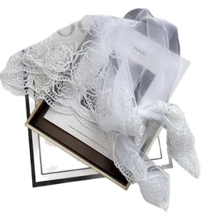 Elegant white mesh shawl featuring detailed camellia floral lace embroidery on sheer tulle