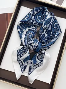 Detail of vintage navy and white paisley silk scarf with smooth glossy texture