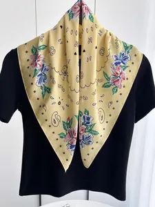 Close-up of yellow pastoral floral paisley print scarf with soft silky texture