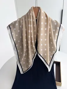 Detailed texture of khaki polka dot scarf with contrast border on black clothes