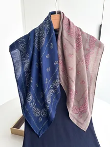 Macro view of paisley print on navy and pink cotton linen scarf hanging on hanger