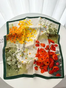 Detail of floral georgette scarf with red poppies and yellow wildflowers on a white table