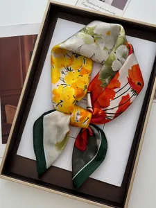 Detailed view of floral silk scarf in elegant gift box with premium satin texture