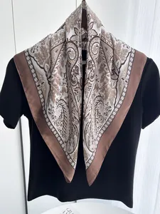 Detail of vintage paisley silk scarf with brown borders and elegant floral patterns